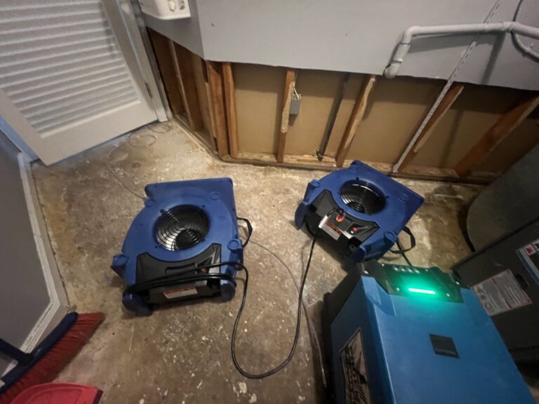 Industrial air movers and dehumidifier drying water-damaged interior with exposed walls, providing water damage restoration services in Staten Island, NY